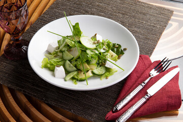 Avocado and cucumber salad in a plate.
