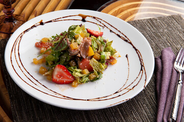 Salad with meat in a plate.