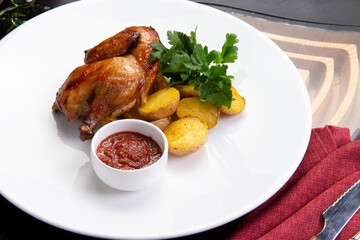 Half a fried chicken and a baked potato in a bowl.