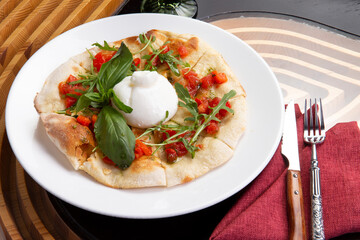 Focaccia with buratta cheese in a plate.