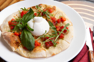 Focaccia with buratta cheese in a plate.