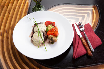 Beef midallions with pepper sauce in a plate.