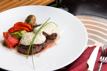 Beef midallions with pepper sauce in a plate.