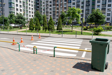 Applying road markings. Pedestrian crossing on the street in the yard. Cones