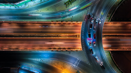 Financial technology, energy power, beautiful top view time-lapse of car traffic at roundabout lane and buildings. 4K drone aerial zoom out. Urban cityscape concept or abstract of advanced innovation.