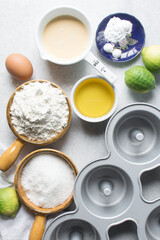 Overhead view of mise en place of ingredients for making a lemon cake, flatlay of ingredients for making lemon pound cake, process of making cake