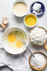 Overhead view of mise en place of ingredients for making a vanilla cake, flatlay of ingredients for making vanilla pound cake, process of making cake