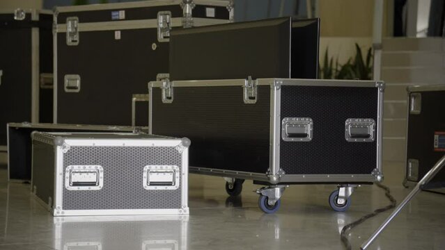 Flightcase of concert music and video equipment stacked behind the stage 