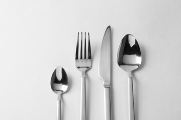 Stylish silver cutlery on white background, flat lay