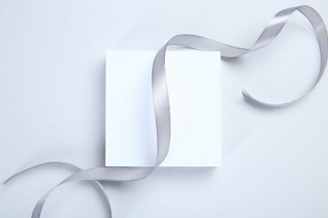 Beautiful grey ribbon and podium on white background, top view