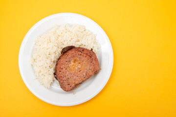 Baked meatloaf with boiled rice on plate