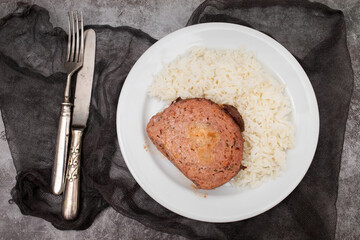 Baked meatloaf with boiled rice on plate