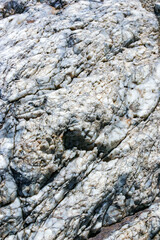 A layer of white quartz among colored rocks in the mountains in Death Valley