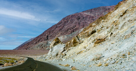 Road along Mountains with colorful rocks in Death Valley in the Arizona desert.