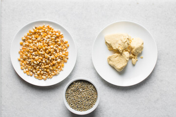 Overhead view of corn millet and nigerian akamu or pap, process of making akamu, flatlay of process of making nigerian akamu ogi pap or corn pudding