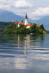 Panoramic view from Lake Bled, beauty heritage in Slovenia. Island with church and castle in the background create a dream setting. View from Ojstrica and Mala Osojnica with the heart-shaped bench.