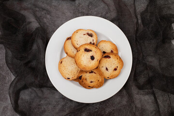 Freshly baked rusks with raisins, on small plate