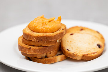 Freshly baked rusks with raisins, on small plate