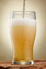 Pouring craft beer. Beer. Glass of fresh and cold beer with drops. Shallow depth of field