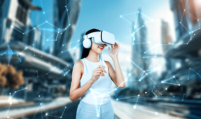 Female standing and wearing white VR headset and white sleeveless connect metaverse, future...