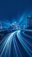 Fototapeta premium Nighttime city street with colorful light trails from moving cars. Headlights guiding the way to a towering skyline, illustrating the motion and vibrancy of the futuristic metropolis.