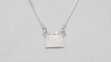 Handmade Hmong or Miao silver jewelry display on white background