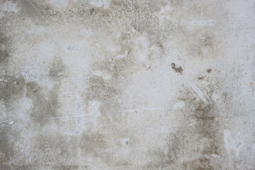Gray concrete wall with scratches and dirty stains