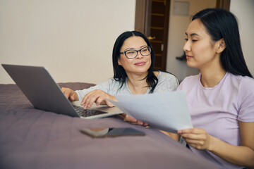 Family of two making online bill payment using laptop