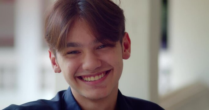 A happy smile of a handsome male high school student who is half Asian-European.