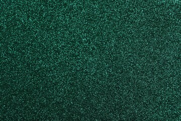 Shiny dark green glitter as background, closeup