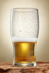 Craft beer. Half of fresh and cold beer with drops in a pint glass. Craft beer. Shallow depth of field