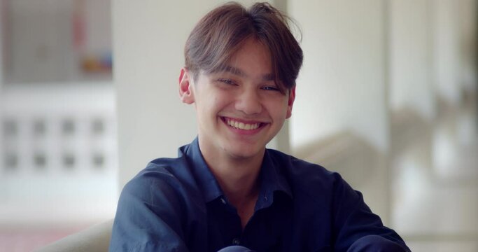 A happy smile of a handsome male high school student who is half Asian-European.