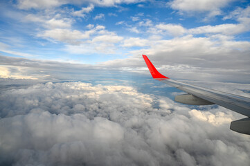 Airplane wing and dramatic sky in the background. Beautiful clouds and clear sky.