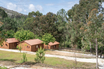 A picturesque group of cabins in a European mountain vacation camp, surrounded by nature. High quality photo