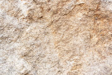 A detailed close-up of a rustic stone background featuring an array of orange and yellow hues, creating a vibrant and textured surface. High quality photo