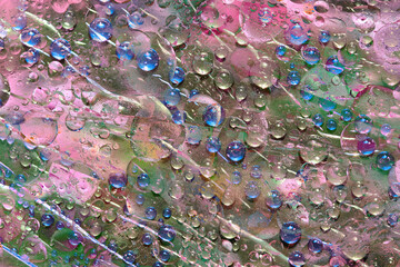 Blue raindrops falling down against the green-pink background. Abstract fantasy. 3D render.