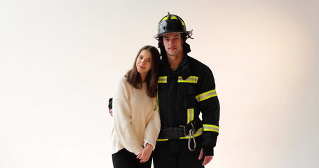 The fireman hugs the girl who is happy that he returned unharmed. Footage of a firefighter with a...