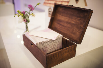 wood box for cards at wedding reception. wooden wedding box for cards, money, gifts for newlyweds on the table. Wedding accessories. Donation box