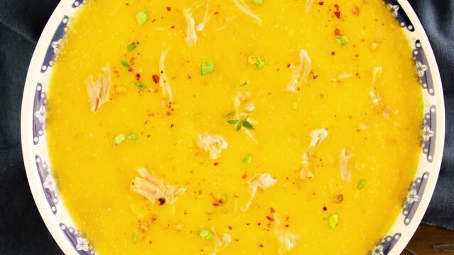 Pumpkin shredded chicken breast soup with herbs and spices