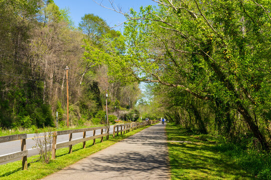 Background of greenery path. Roswell Riverwalk Boardwalk is a 7-mile off-road path that runs along the Chattahoochee River in Roswell, Georgia, Fulton County. A beautiful walking path along the river