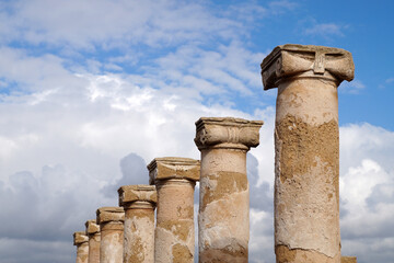the upper part of the ancient temple columns against the sky in the archaeological park of Kato Paphos