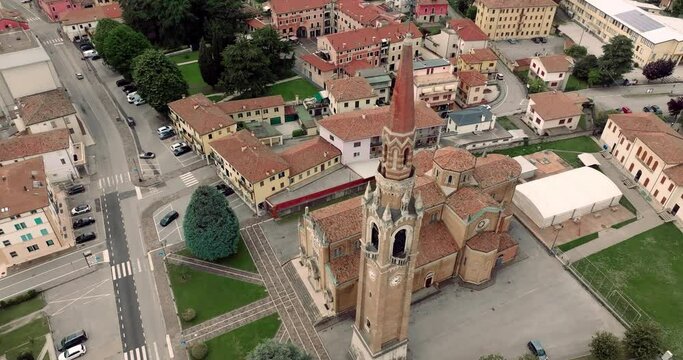 Aerial View of Cornuda, Italy: Cathedral Architecture and Bell Tower in Urban Landscape. High quality 4k footage
