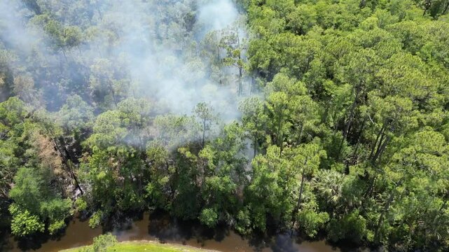 Aerial shot of a large brush fire erupted at Charlie Wheeler Community Park, located in Poinciana.