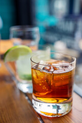 Close up of a freshly pour whiskey with ice. Drinking is not good for a healthy lifestyle. Idea for occasional drinks to celebrate a wedding, birthday or new year celebration party