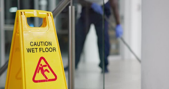 Person, mopping and office with caution sign, janitor and hygiene service and wet floor for healthcare. Attention, safety and warning for risk, dancing and cleaner happy for cleaning or maintenance
