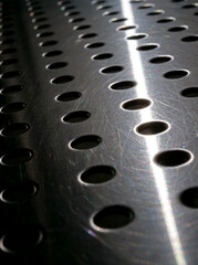 close-up perforated metal textured industrial background