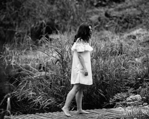 Portrait of a young beautiful dark-haired girl. Black and white photo.