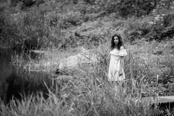 Portrait of a young beautiful dark-haired girl. Black and white photo.