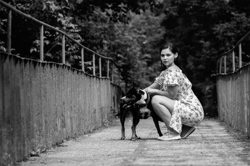 Portrait of a young beautiful dark-haired girl. Black and white photo.