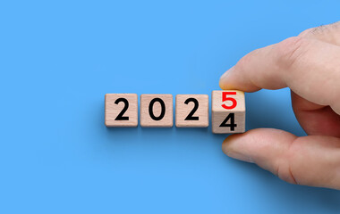 Symbolize the transition from 2024 to 2025 with Wooden Blocks for a festive New Year celebration....